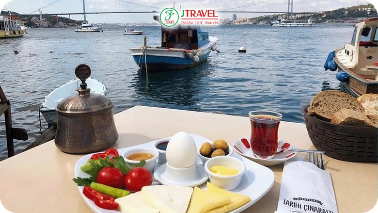 Người bán trà dạo cầm khay cốc tulip trên phà qua eo biển Bosphorus